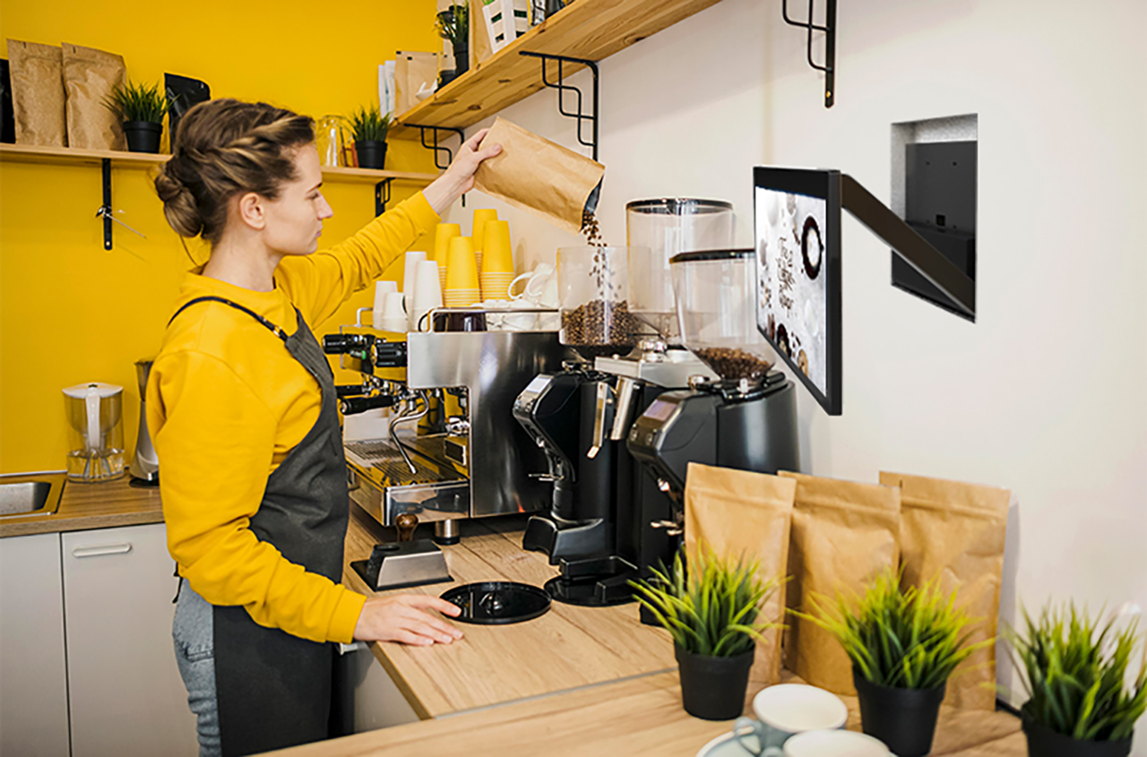  A clerk making coffee in front of SENOR AOI POS in a coffee shop