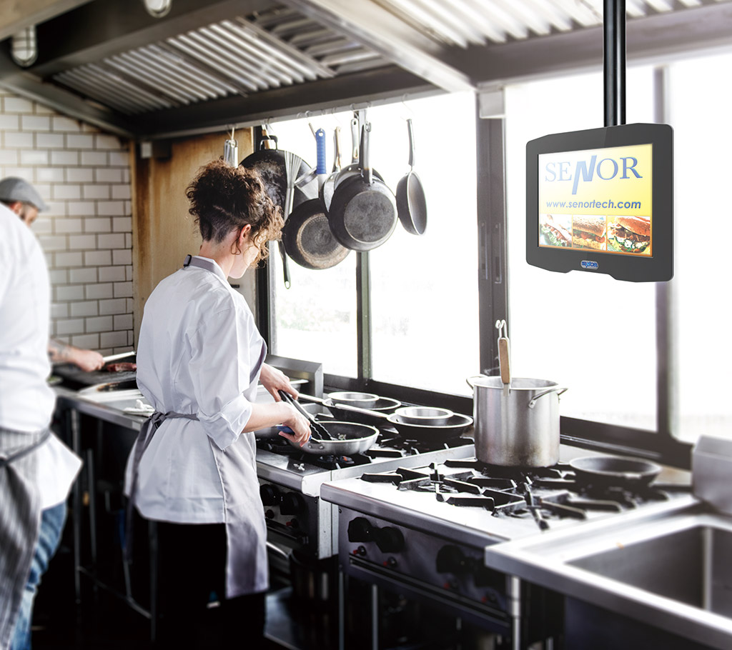 SENOR_A female chef of a restaurant prepares and cooks ingredients through the POS system in the kitchen.