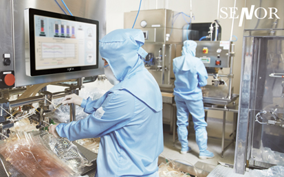 Two professionals in a food factory are processing packaging products by operating Senor Industrial tablet PC.